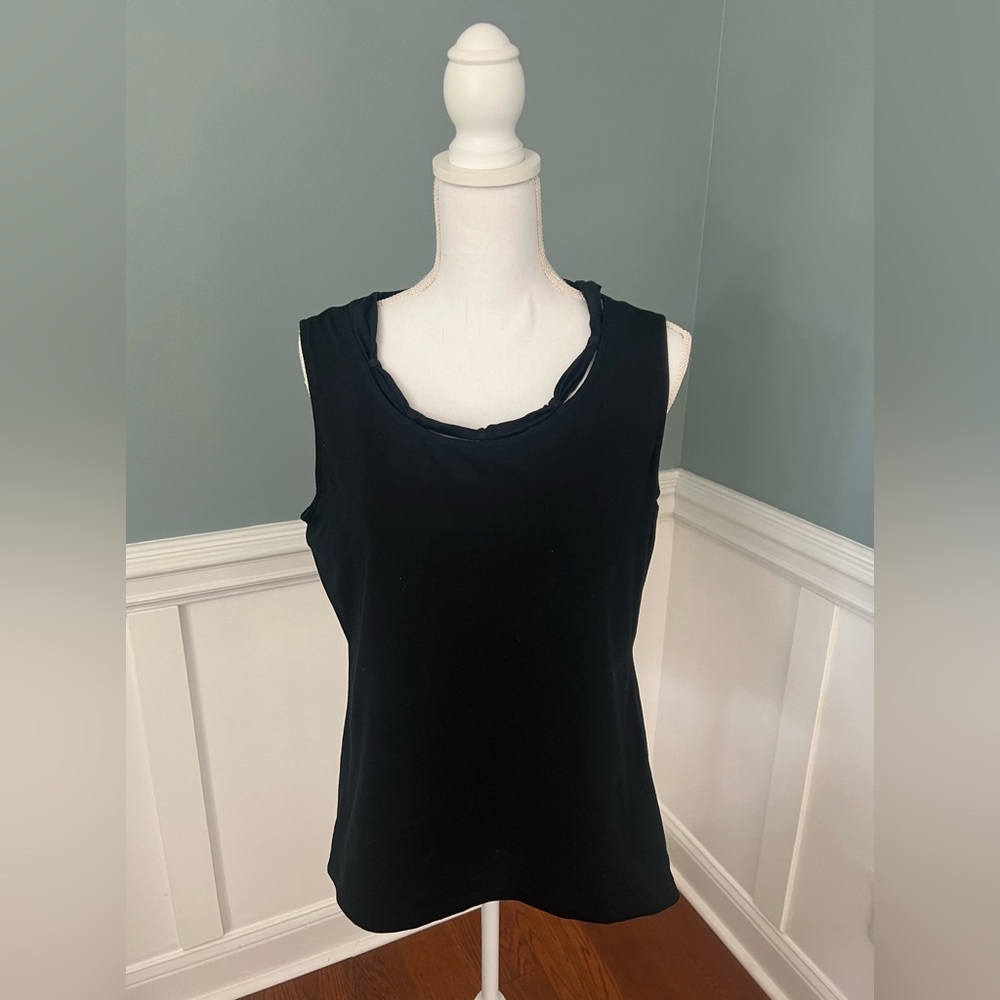 Women’s black top with detail at neckline. Sleeveless top.